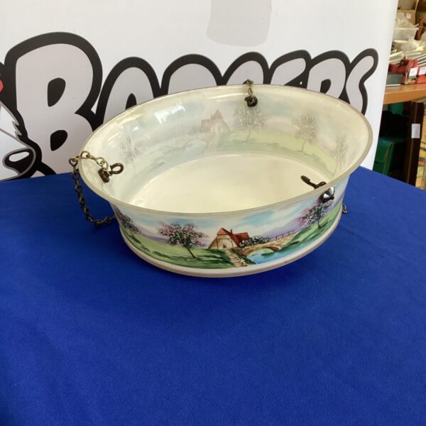 Vintage floral ceiling light shade with chain suspension.