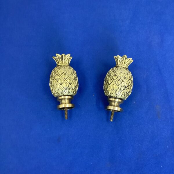 Vintage brass pineapple curtain rail ends, decorative finials.