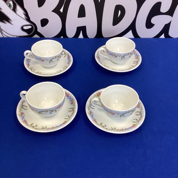Vintage Limoges coffee cup set with floral details.