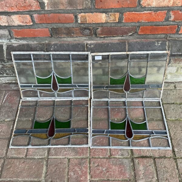 Four vintage stained glass windows with amber panels.