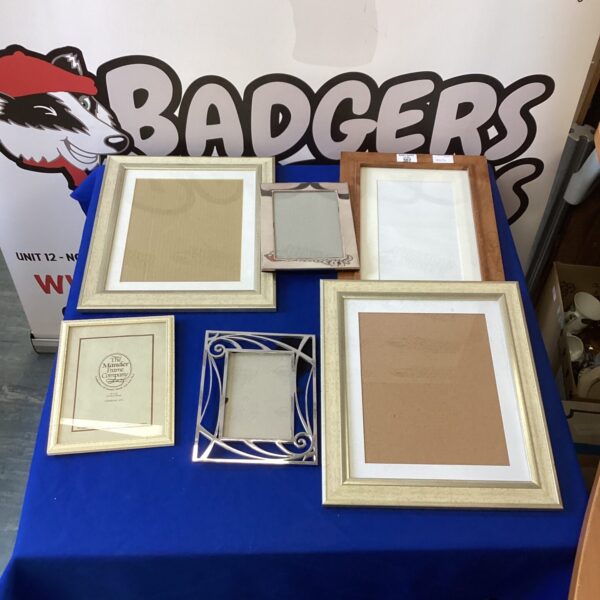 Assorted vintage picture frames for wall decor and photos.