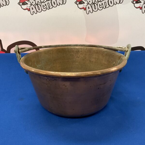 Vintage copper jam pan with iron handles, ideal for preserving.