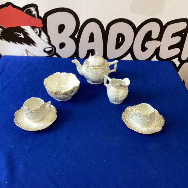 Delicate Victorian bone china tea set with floral details.