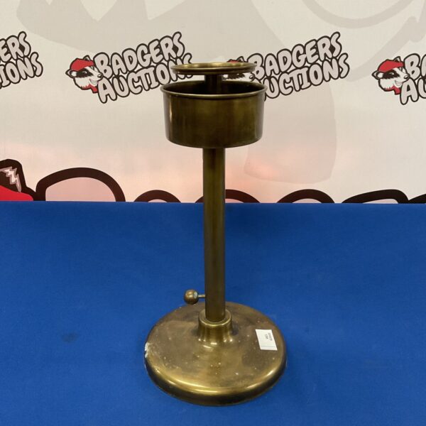 Antique brass adjustable candlestick with a classic design.