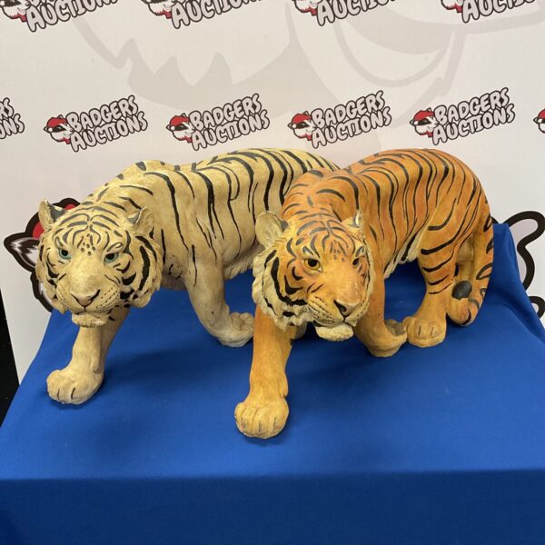 Two large fibreglass tiger statues for garden decor.