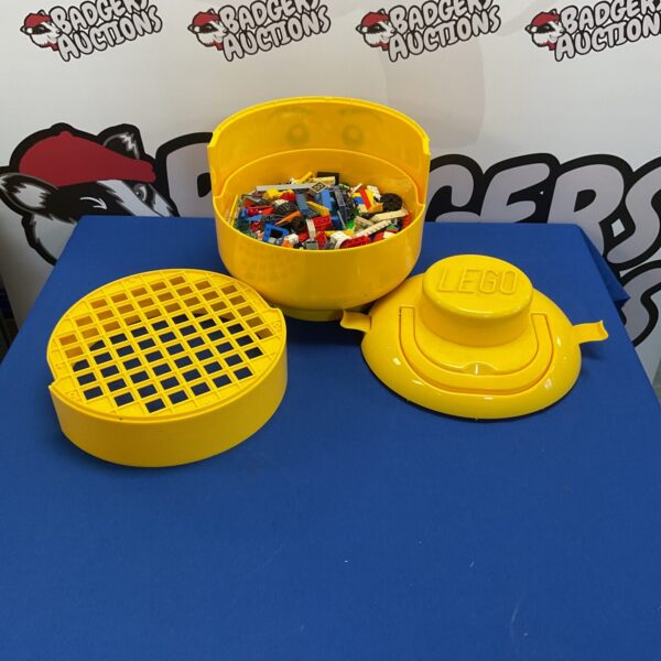 Yellow Lego head-shaped lid for storage box.