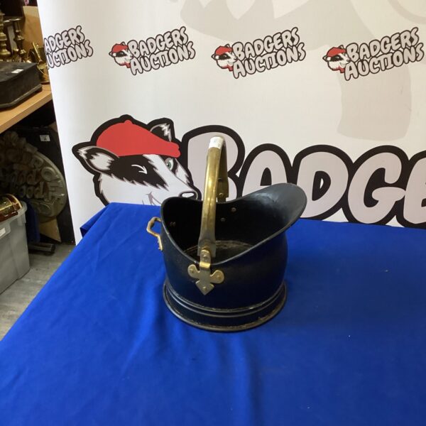 Antique metal coal bucket for fireplace use.