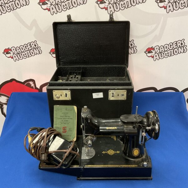 Vintage Singer Featherlite sewing machine in carrying case.