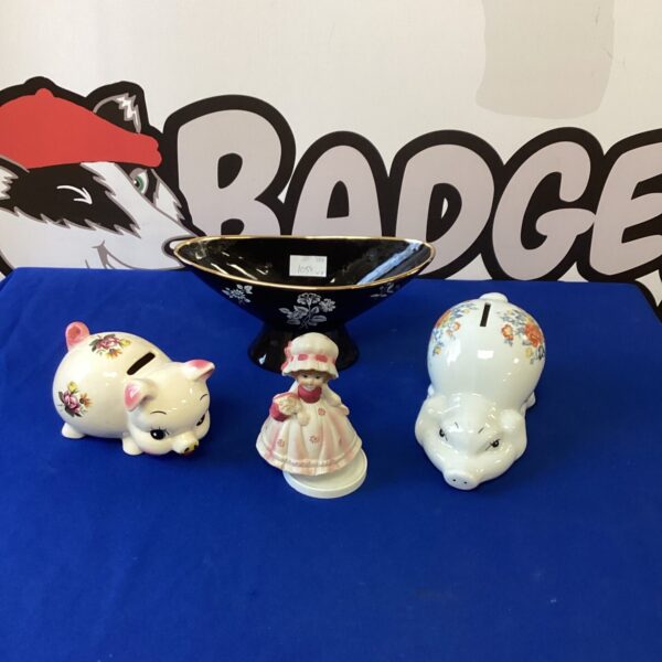 Close-up of vintage porcelain piggy banks with floral patterns.
