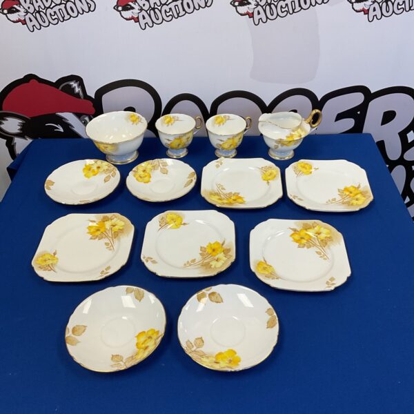 Vintage Shelley yellow flower bone china tea set on display.