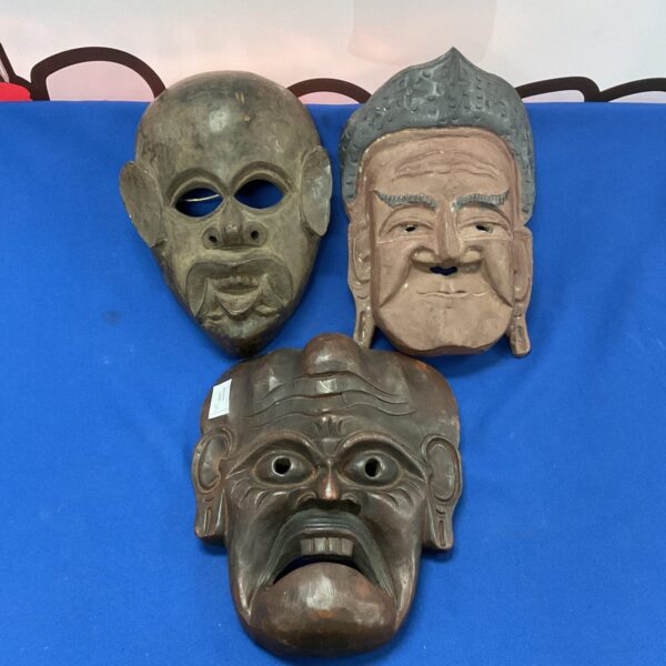 Set of three vintage carved oriental masks for collectors.