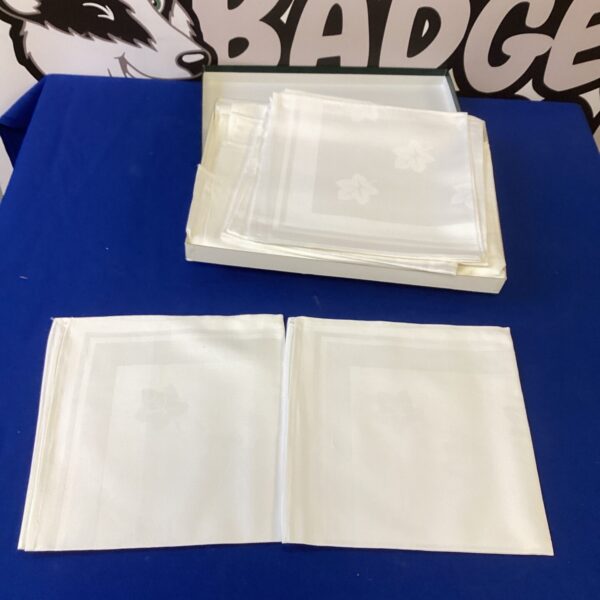 Stack of vintage white linen napkins for table setting.