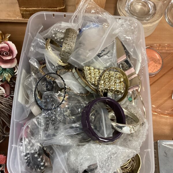 Assortment of vintage costume jewellery including necklaces and brooches.