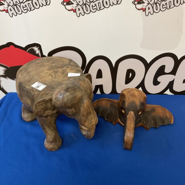 Vintage carved wooden elephant footstool with detailed texture.