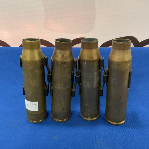 Four brass 30mm AFV bullet cases, military ordnance collectible.