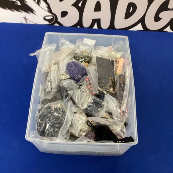 Costume jewellery lot with necklaces, brooches, and earrings.
