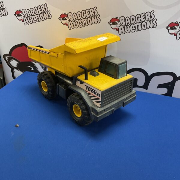 Yellow vintage Tonka dump truck, classic metal toy.