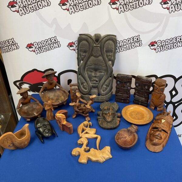 Diverse collection of tribal carvings including African and Mauri art.