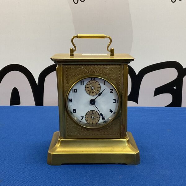 Antique German musical alarm carriage clock with brass casing.