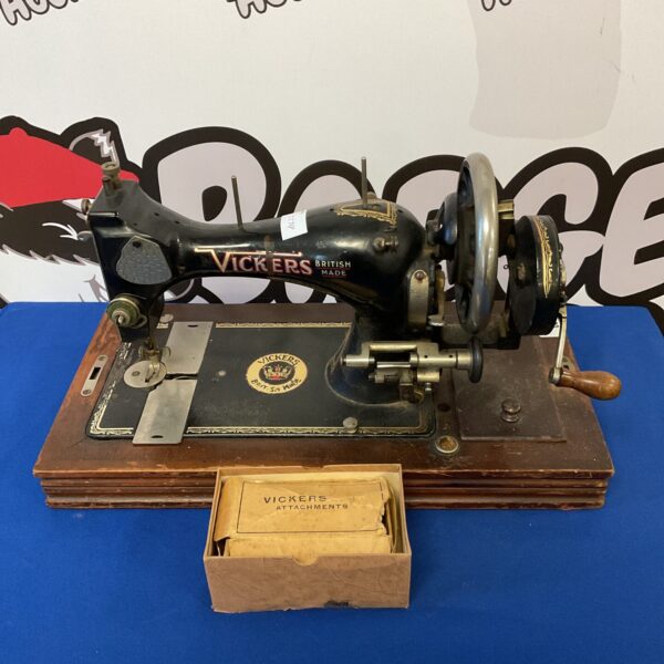 Vintage Vickers hand-cranked sewing machine with attachments.