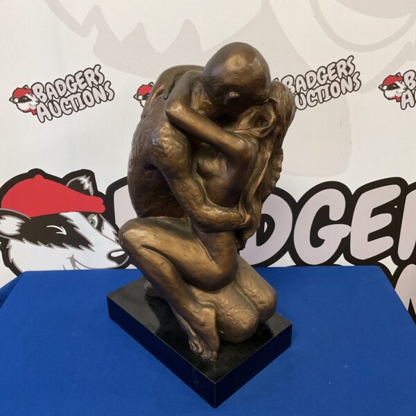 Bronze sculpture of a couple embracing by Austin.