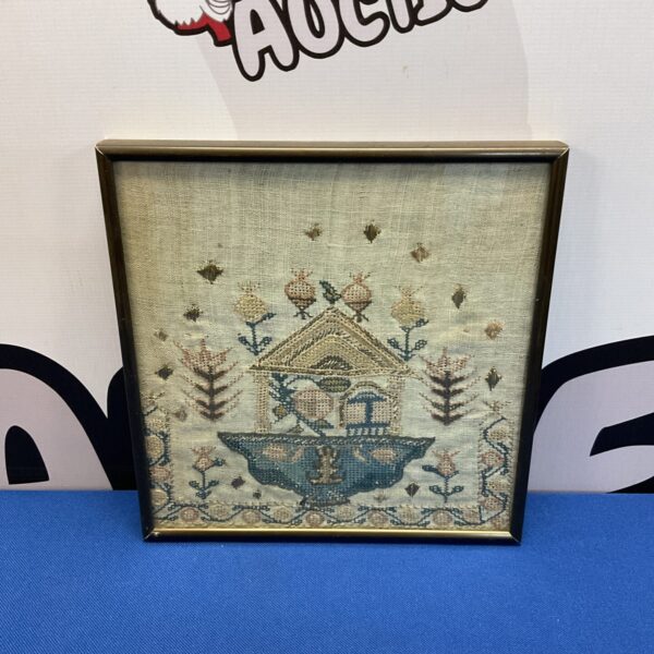 Antique temple embroidery framed in wood, detailed needlepoint.