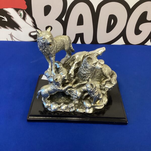 Detailed pewter wolf pack sculpture for home decor.