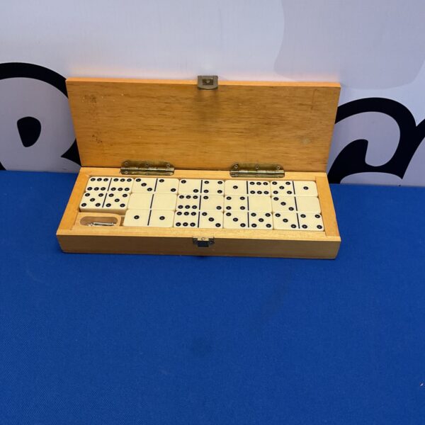 Vintage oak cased dominoes and cribbage set for classic games.