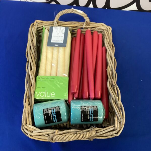 Woven basket filled with scented candles for home fragrance.