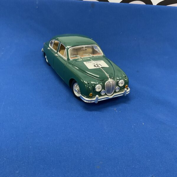 Green Maisto Jaguar MK2 diecast model car on display.