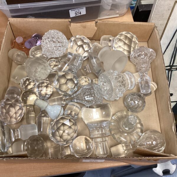 Assorted glass decanter stoppers in a selection for collectors.
