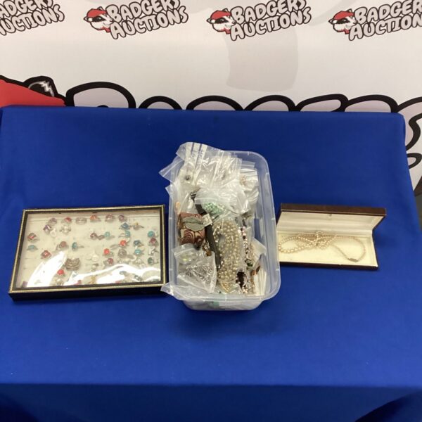 Costume jewellery lot with rings and necklaces on display.