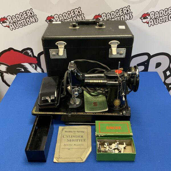 Vintage Singer Featherlight sewing machine model 99K with attachments.