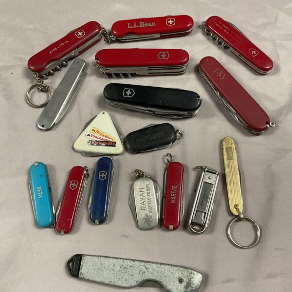 Assorted vintage Swiss Army knives by Victorinox in a collection.