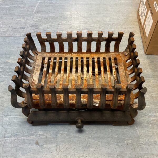 Antique cast iron fireplace grate with decorative bars for efficient burning.
