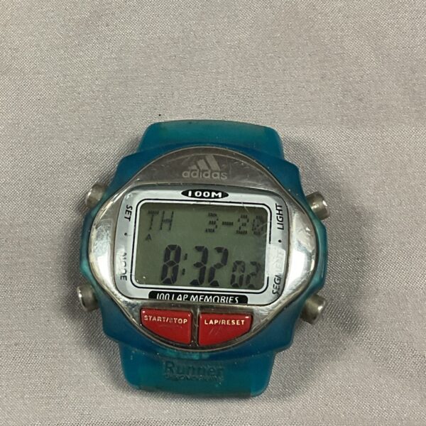 Vintage adidas digital watch with a grey strap.