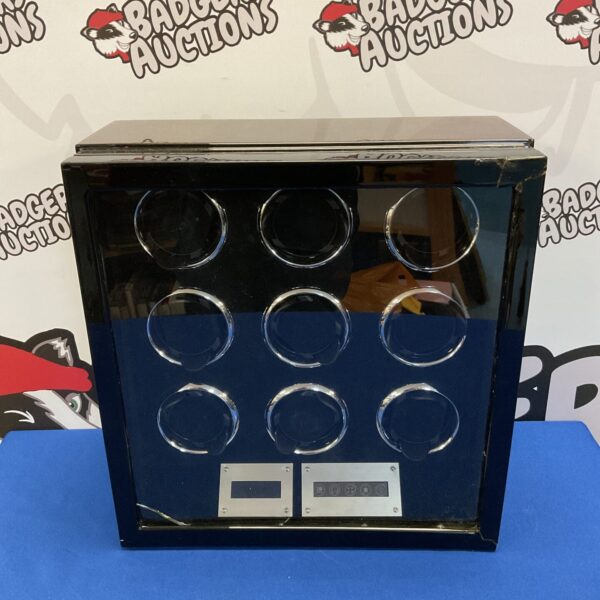 Dark watch winder with nine spaces for automatic watches.