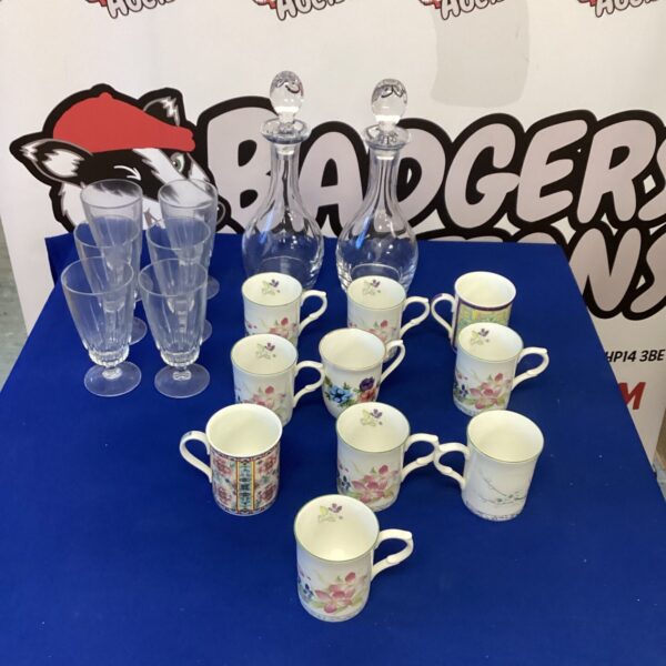 Collection of vintage patterned china mugs on a table.