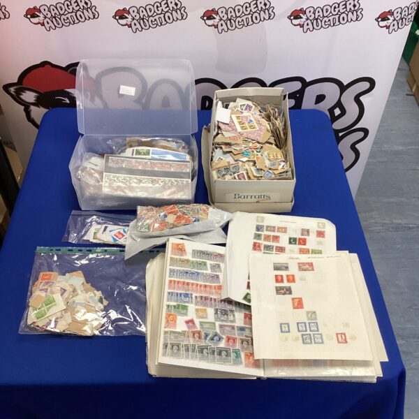 Large stamp collection with diverse worldwide stamps in protective sleeves.