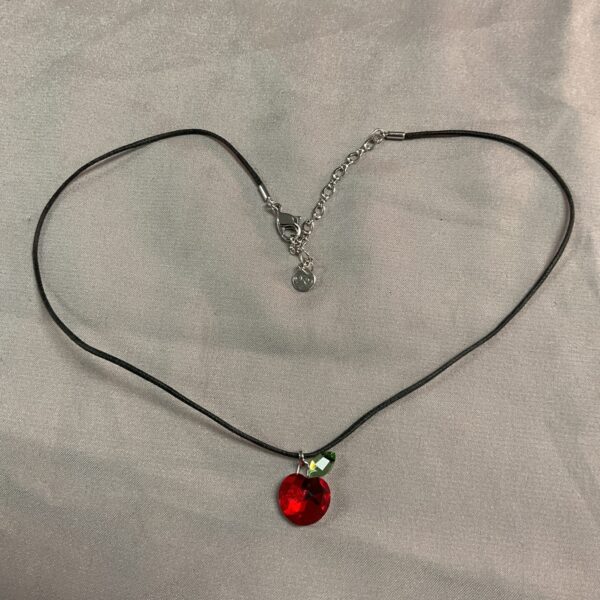 Vibrant red Swarovski crystal pendant necklace on black cord.