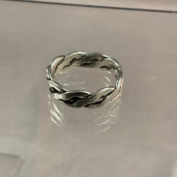 Close-up of a silver braided ring, size O.