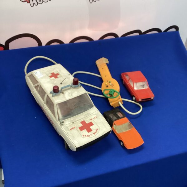 Vintage red and white remote control car with remote.