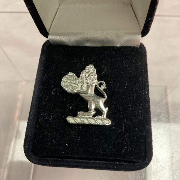 Detailed silver lion pin badge with heraldic design.