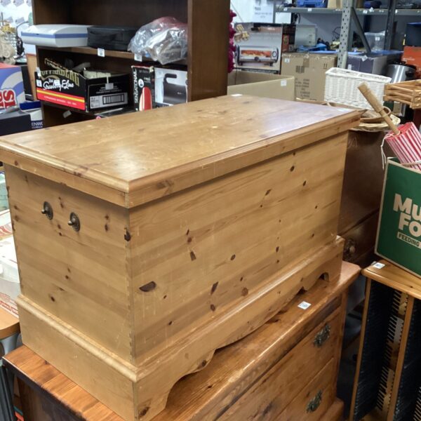 Vintage pine blanket chest with lift-top lid for storage.