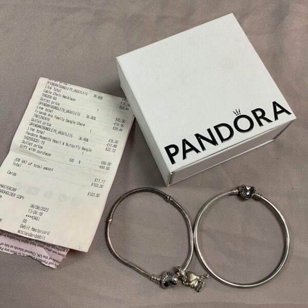 Silver Pandora bangles featuring heart and butterfly motifs.