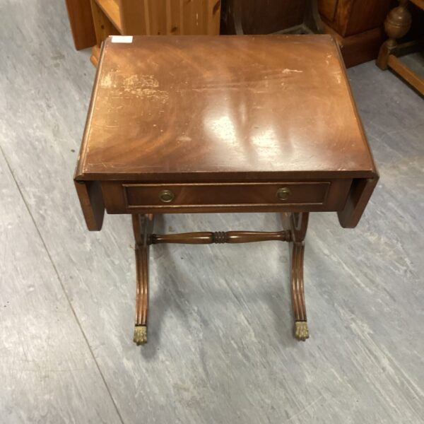 Antique mahogany drop leaf table with claw feet.