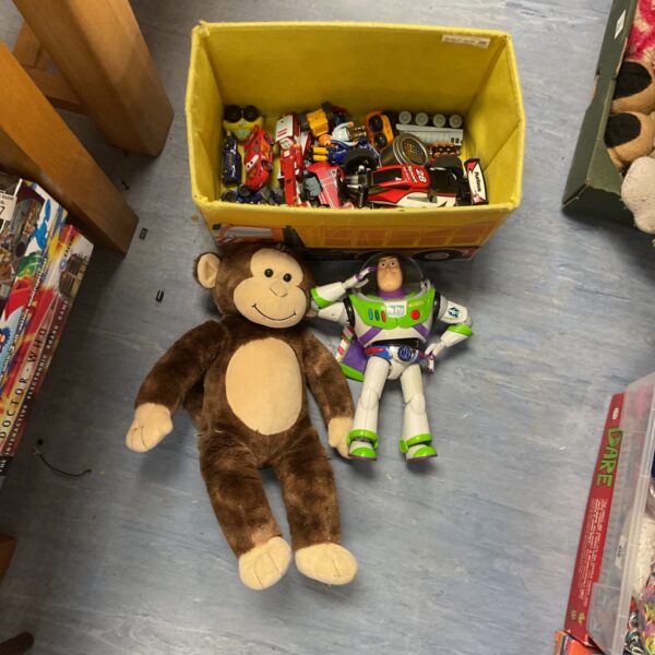 Mixed toy lot featuring Buzz Lightyear, diecast cars, and an RC car.