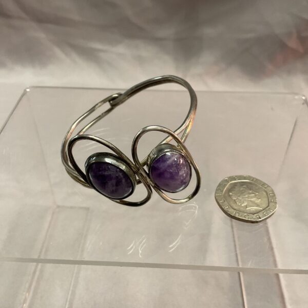 Vintage silver bracelet with amethyst gemstones, bold statement piece.