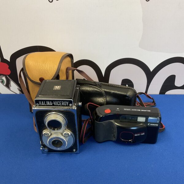 Vintage Halina Viceroy and Canon Sure Shot cameras on display.