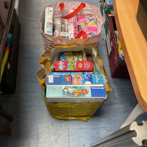 Mixed lot of puzzles and board games including Ravensburger and Disney titles.